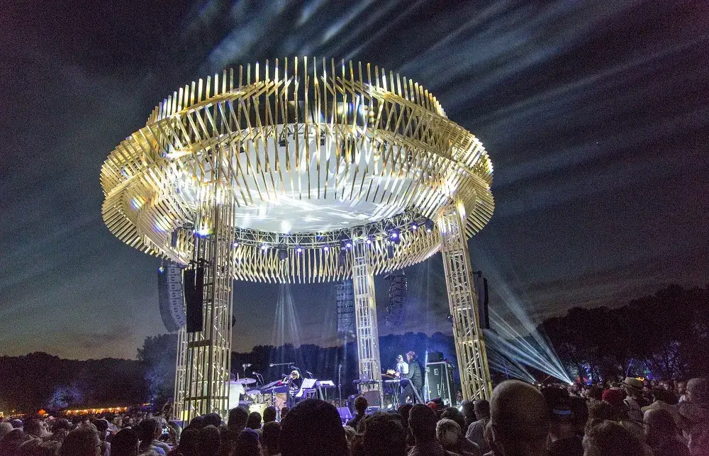 A crowd of people standing around a metal structure.